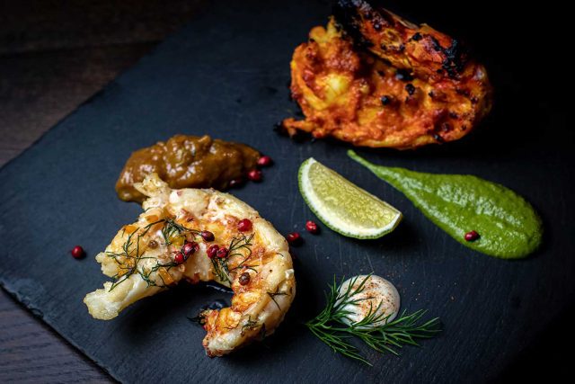 Vibrant tandoori prawn tikka garnished with fresh lime and zesty chutney, served as part of a celebratory Diwali menu at Masalchi in Wembley Park.