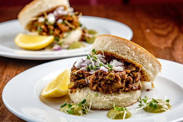 Spiced keema served with soft pav bread, vibrant green chutney, and a wedge of lemon, prepared for home delivery by Masalchi in Wembley Park.