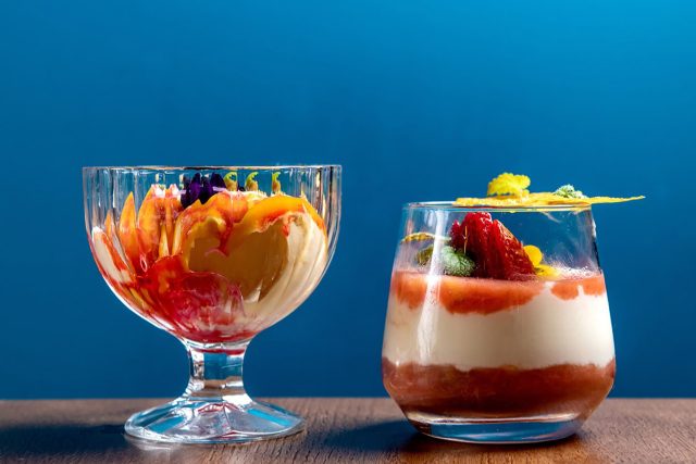 A refreshing mango kulfi falooda layered with fruit compote, served in an elegant glass at Masalchi in Wembley Park.